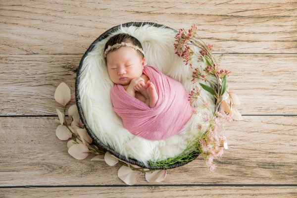 花の髪飾りをつけて眠る赤ちゃん